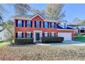 Charming two-story brick home with manicured landscaping and an attached two-car garage at 2697 Links Overlook Drive Dr, Dacula, GA 30019