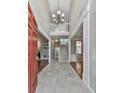 Grand foyer with high ceilings, stone flooring, staircase, and chandelier at 4880 Hunters Oaks Ln, Alpharetta, GA 30009