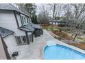 Backyard featuring a swimming pool, patio, and lush landscaping at 4880 Hunters Oaks Ln, Alpharetta, GA 30009