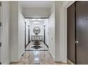 Hallway view with black and white floors, chandelier, mirror, and elevator access at 3040 Peachtree Nw Rd, Atlanta, GA 30305