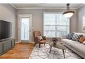 Inviting living room with hardwood floors, large windows, and stylish modern furniture at 1126 Village Se Ct, Atlanta, GA 30316