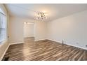 Bright living room featuring new flooring and a modern light fixture at 2248 Greenway Drive, Decatur, GA 30035