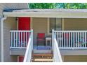 Upstairs front porch and entrance with a red door and chairs for relaxing at 2937 Torreya Way, Marietta, GA 30067