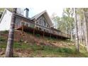Charming home featuring a spacious deck, ideal for outdoor entertaining in a peaceful wooded setting at 8155 Stone Hill Rd, Cumming, GA 30028