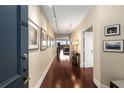 Elegant hallway with hardwood floors leading to a bright living space with outside views and neutral paint at 2660 Peachtree Nw Rd # 14D, Atlanta, GA 30305