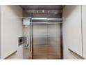 Modern stainless steel elevator with user panel and floor indicator at 112 Rogers St # 409, Atlanta, GA 30317