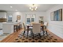 Elegant dining room with hardwood floors, a round table, and a modern chandelier at 6 Walnut Hill Nw Pl, Atlanta, GA 30318