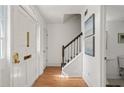 Bright entryway featuring hardwood floors, white walls, and a staircase with wooden railing at 6 Walnut Hill Nw Pl, Atlanta, GA 30318