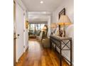 Inviting entryway with hardwood floors, console table and a view into the stylish living room at 2575 Peachtree Ne Rd # 8D, Atlanta, GA 30305
