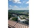 Enjoy city views from this balcony, showcasing a community pool and lush trees at 3481 Lakeside Ne Dr # 2303, Atlanta, GA 30326