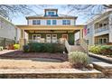 Inviting two-story home with a covered front porch and beautifully maintained landscaping at 1564 Spring Se St, Smyrna, GA 30080