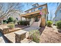 Two-story home with a lovely covered front porch, showcasing its attractive curb appeal at 1564 Spring Se St, Smyrna, GA 30080