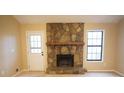 Living room showcasing a stone fireplace, and a bright window for natural light at 326 Rockland Way, Lawrenceville, GA 30046