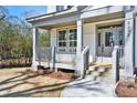 Charming front porch with wood decking and gray railings, leading to the front door at 5272 Poplar Springs Rd, Stone Mountain, GA 30083