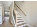 Bright staircase with combination of wood treads and black iron railings at 5272 Poplar Springs Rd, Stone Mountain, GA 30083