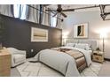 Comfortable bedroom features a cozy rug, neutral walls and a decorative blanket on the bed at 1261 Caroline St # 211, Atlanta, GA 30307