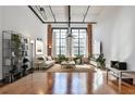 Bright living room boasts exposed brick, large windows, high ceilings and gleaming hardwood floors at 1261 Caroline St # 211, Atlanta, GA 30307