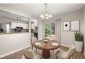 Cozy dining area with modern lighting and a view of the backyard at 2003 Queen Anne Ct, Sandy Springs, GA 30350