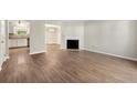 Open-concept living space with fireplace and hardwood flooring at 2003 Queen Anne Ct, Sandy Springs, GA 30350