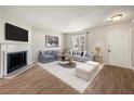 Bright living room with a cozy fireplace, plush seating, and modern decor at 2003 Queen Anne Ct, Sandy Springs, GA 30350
