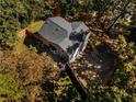 Beautiful aerial view of the home with a private backyard, driveway, and surrounding trees at 725 Dena Dr, Canton, GA 30114