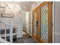 Bright foyer with a staircase and stylish wood-look flooring, offering a cozy and modern entrance at 725 Dena Dr, Canton, GA 30114