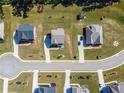 Aerial view of homes in a neighborhood with landscaped yards and circular cul-de-sac street at 1468 Harlequin Way, Stockbridge, GA 30281