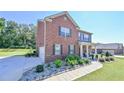 Charming two-story brick home featuring an attached garage and well-maintained landscaping at 1468 Harlequin Way, Stockbridge, GA 30281