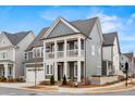Beautiful gray two-story home featuring a charming front porch, white trim and a two car garage at 800 Castile Ln, Woodstock, GA 30188