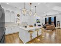 Open kitchen and living area with a marble countertop island and modern lighting at 1774 Vesta Ave, Atlanta, GA 30337