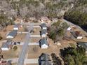 An aerial view of an attractive home and neighborhood featuring well-manicured lawns and mature trees at 9630 Carolina Drive, Jonesboro, GA 30238