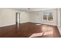 Large living room featuring hardwood floors, white walls, and a front entry door at 1964 Hollywood Nw Rd, Atlanta, GA 30318
