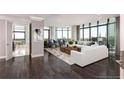 Bright living room with floor to ceiling windows, hardwood floors, and two white sofas with decorative pillows at 750 Park Ne Ave # 19E, Atlanta, GA 30326