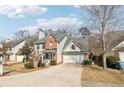 Attractive two-story home with a brick facade and a well-maintained lawn and driveway at 1902 Elm Park Dr, Hampton, GA 30228