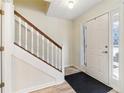 Bright foyer featuring hardwood floors, a staircase with white railings, and a front door with sidelights at 1902 Elm Park Dr, Hampton, GA 30228