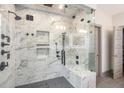 Luxurious walk-in shower with marble tile, multiple shower heads, and glass enclosure at 589 Broadview Ne Pl, Atlanta, GA 30324