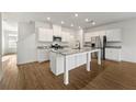 Modern kitchen with white cabinets, granite countertops, stainless appliances, and a central island at 962 Edwin Ln, Sugar Hill, GA 30518