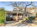 Charming home with covered parking, complemented by a well-manicured lawn and an orange front door at 315 W Benson St, Decatur, GA 30030