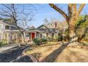 Inviting single-story home with well-kept lawn, a brick-lined flower bed, and an orange front door at 315 W Benson St, Decatur, GA 30030