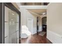 Inviting foyer with hardwood floors, wainscoting, and an arched entryway, creating an elegant first impression at 4205 Idlewood Dr, Cumming, GA 30040