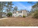 Charming split-level home with tidy landscaping, black shutters, and a quaint light-blue front door at 6645 Doublegate Ln, Rex, GA 30273