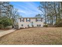Traditional two-story home with a well-kept lawn, inviting front entrance, and lots of natural light at 6645 Doublegate Ln, Rex, GA 30273