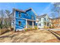 New construction home features a welcoming porch with light blue facade and professional yard grading at 1092 Wedgewood Nw Dr, Atlanta, GA 30318