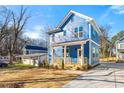 Inviting light blue home with a charming front porch, manicured lawn and an attractive neighborhood view at 1092 Wedgewood Nw Dr, Atlanta, GA 30318