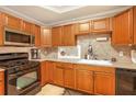Functional kitchen with wood cabinets, stainless steel microwave, and gas range at 2533 Semmes St, East Point, GA 30344