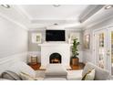 Cozy living room with a brick fireplace, white trim, hardwood floors, and large windows at 2533 Semmes St, East Point, GA 30344