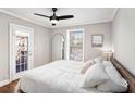Comfortable bedroom with hardwood floors, ceiling fan, and door to outdoor space at 2533 Semmes St, East Point, GA 30344