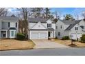 Inviting two-story house with a double garage and a neatly kept front lawn at 1050 Westwell Run, Alpharetta, GA 30022