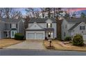 Classic home with a two-car garage, trimmed bushes, and easy street access at 1050 Westwell Run, Alpharetta, GA 30022