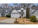 Welcoming two-story home featuring a double garage and neat landscaping at 1050 Westwell Run, Alpharetta, GA 30022